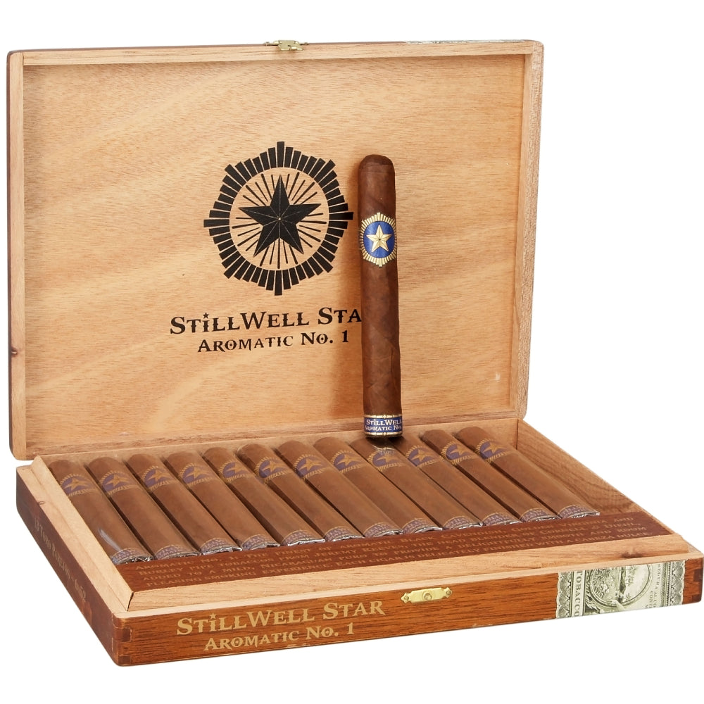 An open wooden cigar box labeled Stillwell Star Aromatic No. 1, containing multiple cigars inside and one standing upright.